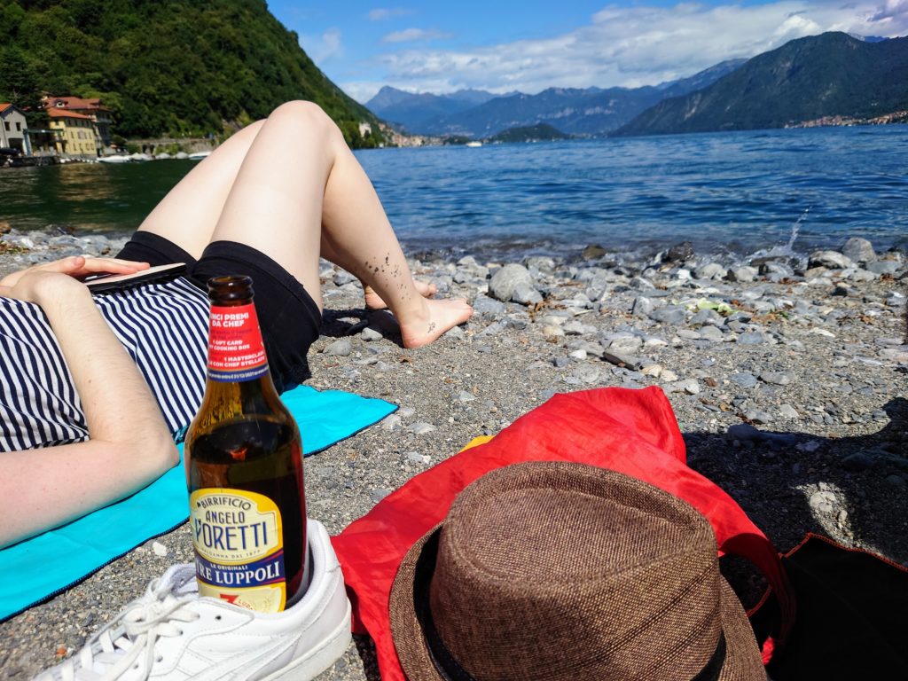 Person relaxing at Lake Como next to Lido di Argegno