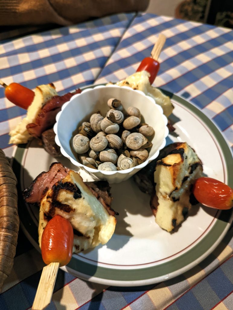 Snails and halloumi cheese on skewers