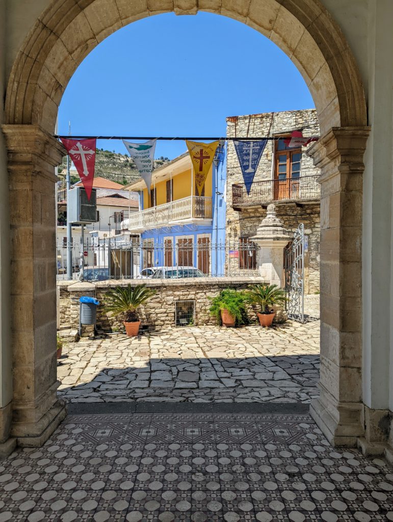 Nicosia doorway with view overlooking traditional houses and flags hanging